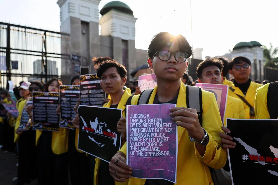 University students hold posters during a protest demanding the release of demonstrators detained during the widespread protests.