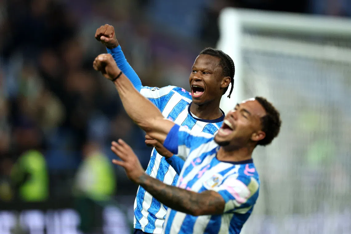 Coventry City’s Stephen Mfuni (left) celebrates after the match.