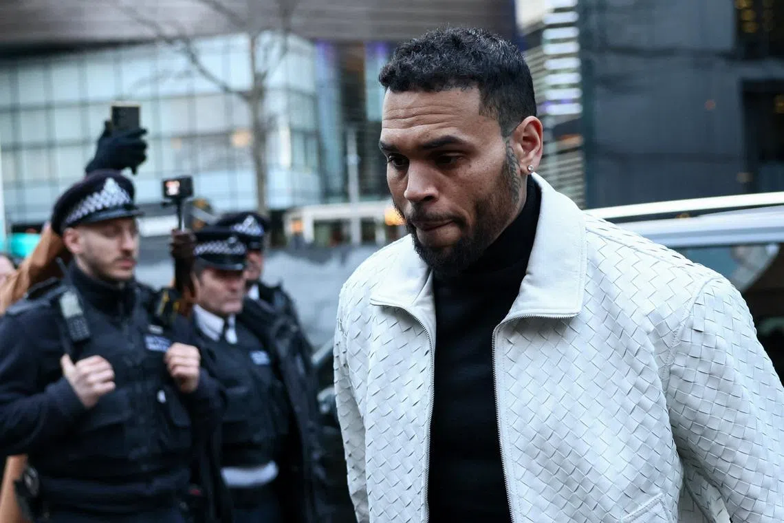 U.S. singer Chris Brown, who has been charged with inflicting grievous bodily harm in what prosecutors said was an \"unprovoked attack\" on a music producer at the Tape nightclub in central London in 2023, walks outside the Southwark Crown Court in London, Britain, January 28, 2026. REUTERS/Jack Taylor