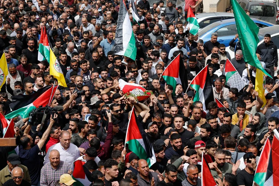 FILE PHOTO: Mourners carry the body of Palestinian-American boy Omar Mohammad Rabea, 14, who was killed by Israeli forces in Turmus Ayya village, during his funeral, near Ramallah in the Israeli-occupied West Bank April 7, 2025. REUTERS/Ammar Awad/File photo