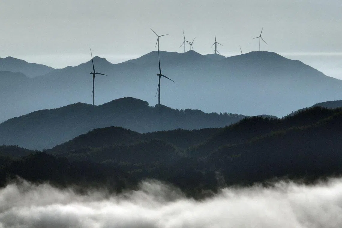 Wind turbines are seen at a wind farm in Suichuan County, in China’s central Jiangxi province on July 17, 2025. 