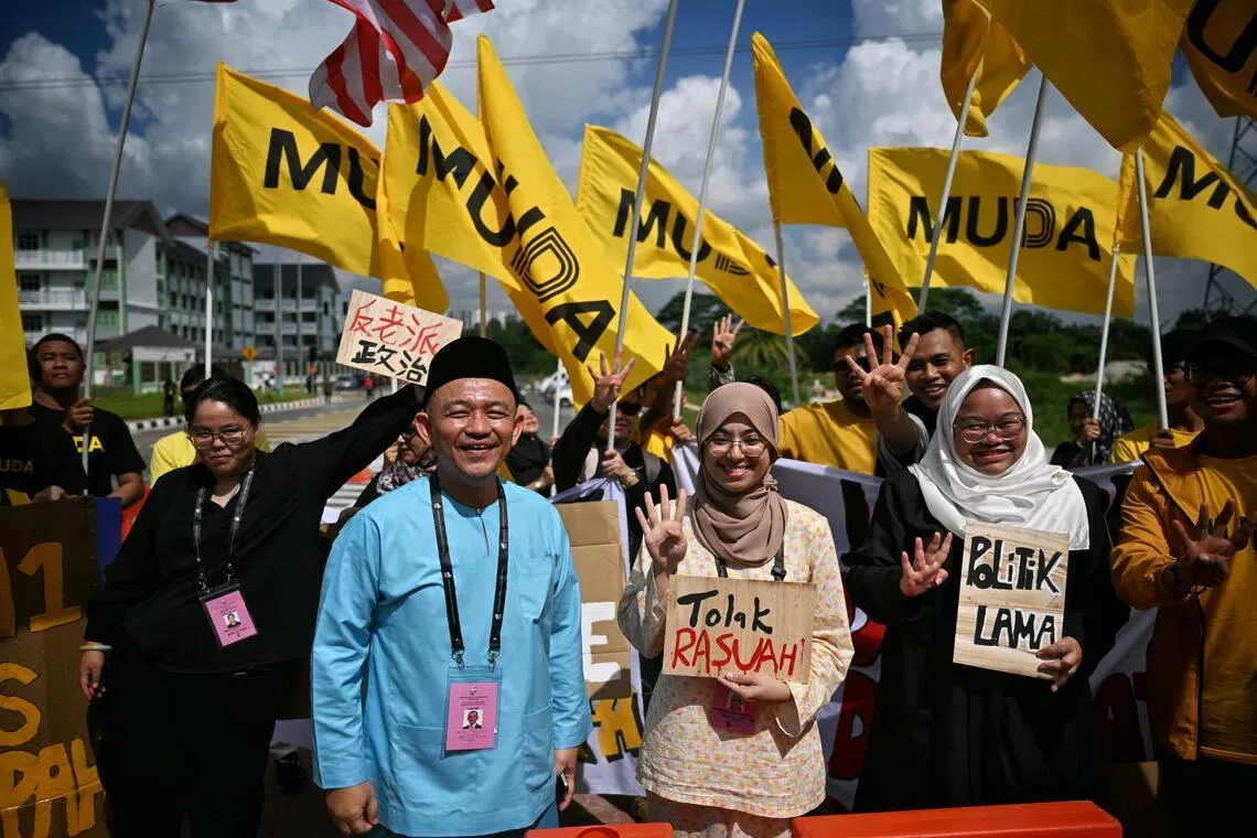 Pakatan Harapan’s Maszlee Malik (left) and MUDA’s Rashifa Aljunied outside the nomination centre on June 27.
