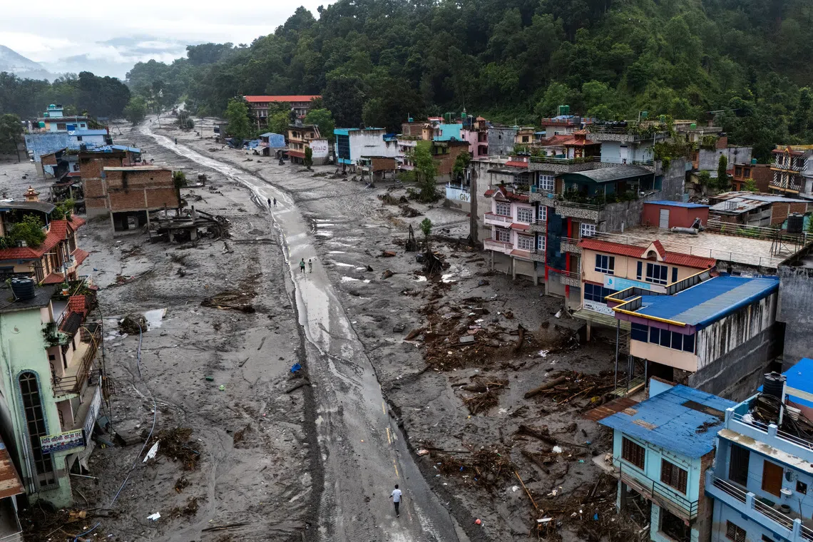 A drone view shows houses covered in mud following deadly flash floods and mudslides, in Devighat, Nuwakot district, Nepal.