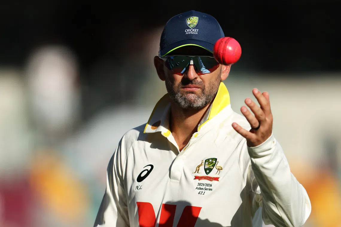 FILE PHOTO: Cricket - The Ashes - Australia v England - Second Test - The Gabba, Brisbane, Australia - December 7, 2025 Australia's Nathan Lyon tosses the ball during the tea break REUTERS/Hollie Adams/File Photo