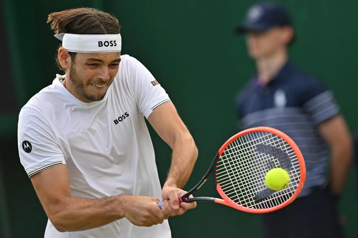 United States player Taylor Fritz returning against France's Arthur Rinderknech during their second-round match.