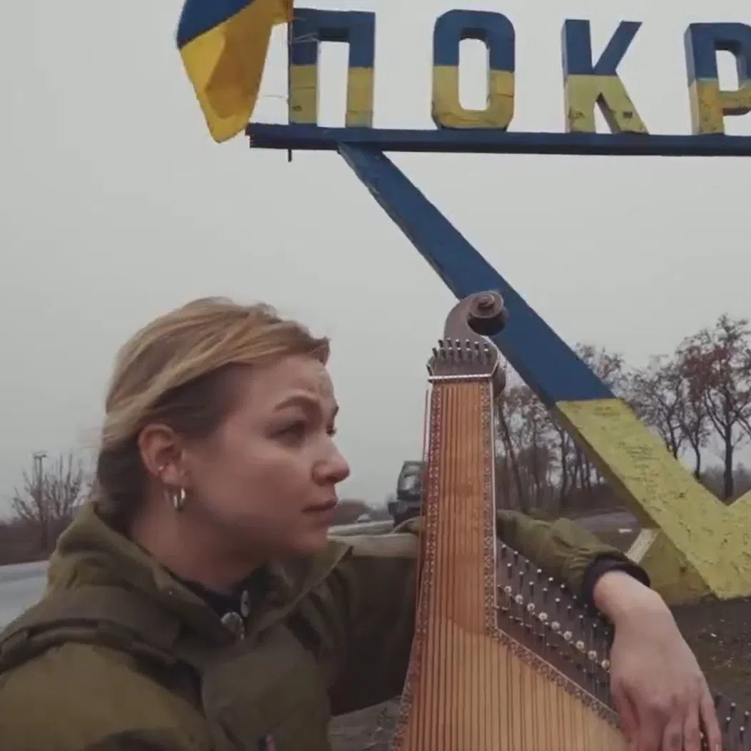 Ukrainian singer Maryna Krut performing Shchedryk - a Ukrainian song known in English as Carol Of The Bells - at the entrance to the Ukrainian city of Pokrovsk in 2024.