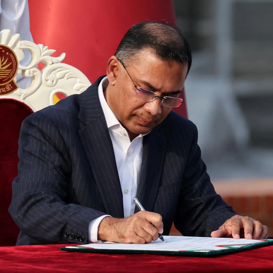 Tarique Rahman signs in as the new Prime Minister during an oath taking ceremony at the South Plaza of the parliament building, following BNP's landslide victory in the national polls, in Dhaka, Bangladesh, February 17, 2026. REUTERS/Mohammad Ponir Hossain/File Photo