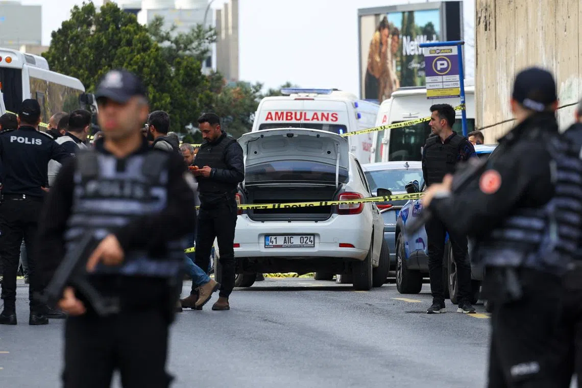 Police officers search a car at the scene, after gunfire was heard near the building housing the Israeli consulate, according to a witness, in Istanbul, Turkey, April 7, 2026. REUTERS/Murad Sezer