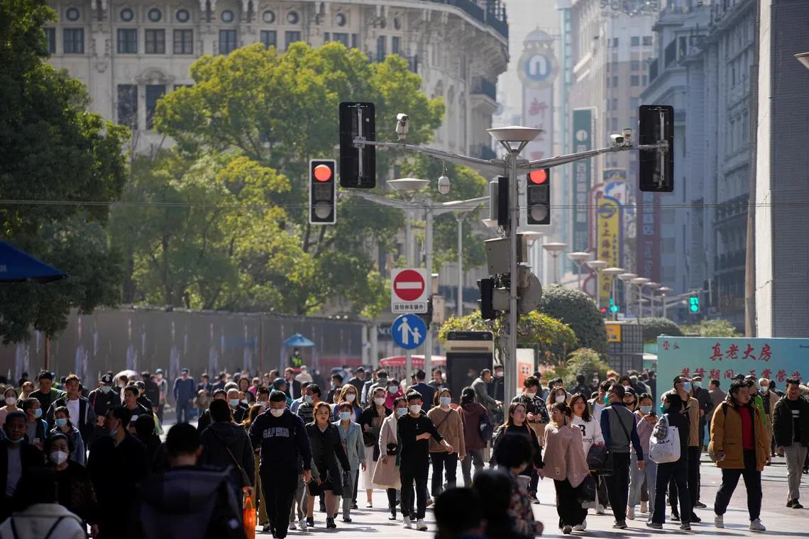 People walk at the main shopping area in Shanghai, China, March 14, 2023. REUTERS/Aly Song