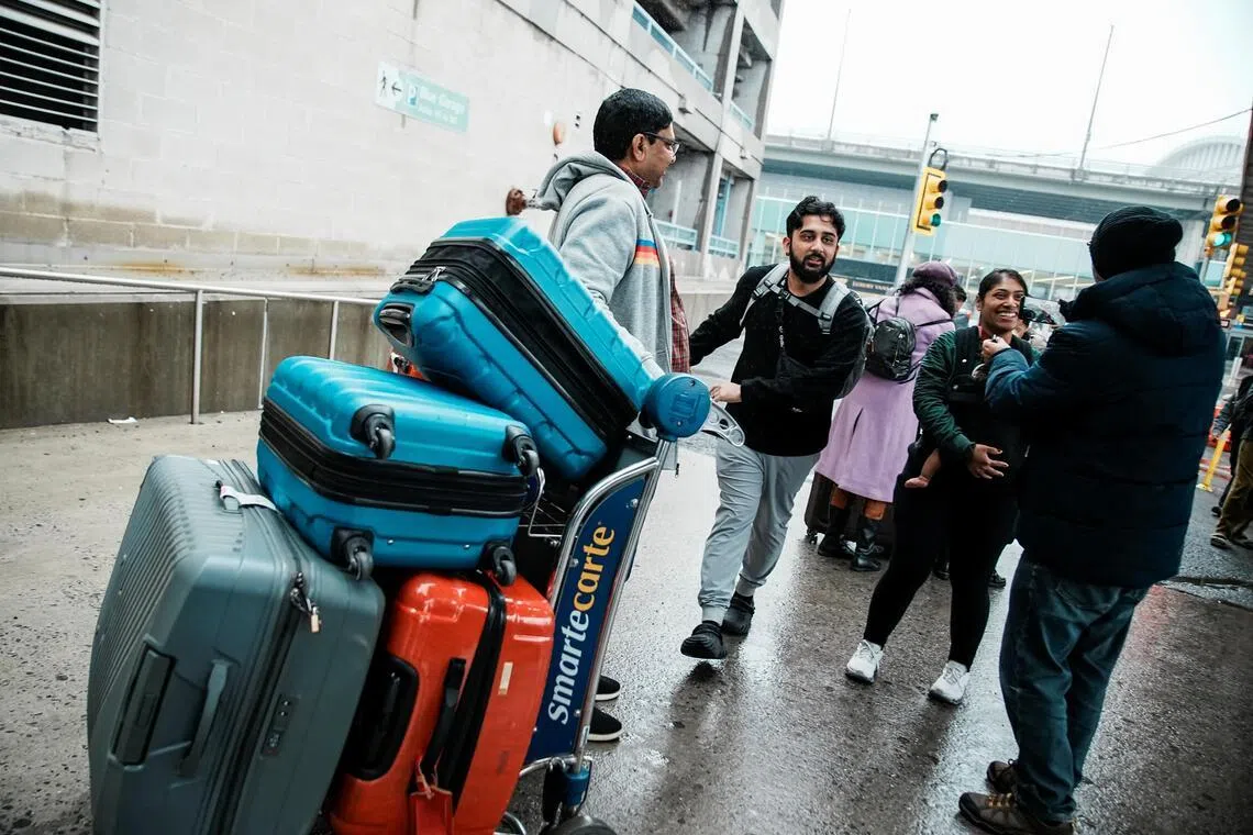 People arriving back in the US from the Middle East on March 5, after taking a US government chartered flight to New York.
