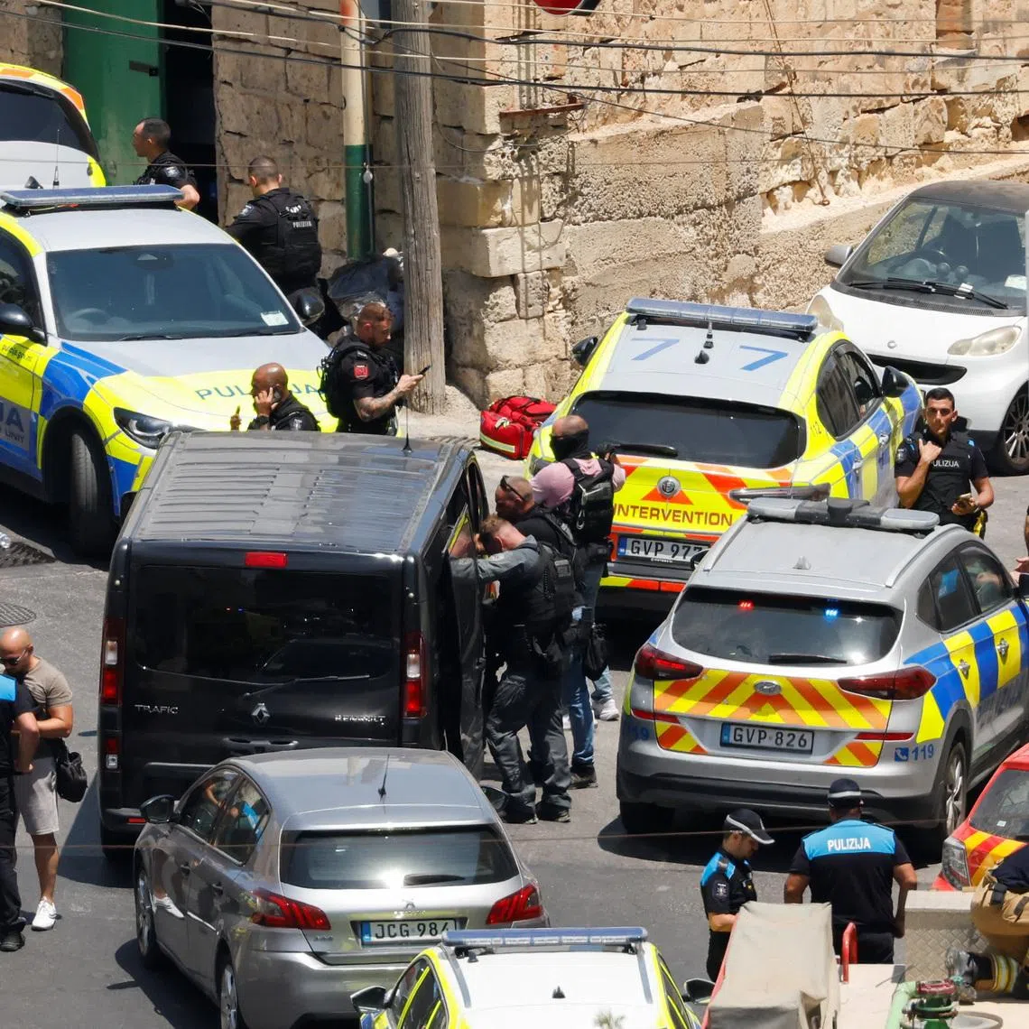 Armed police officers gather outside a building after an operation to arrest a man who shot and injured two police officers in St Julian's, Malta, July 24, 2026. REUTERS/Darrin Zammit Lupi