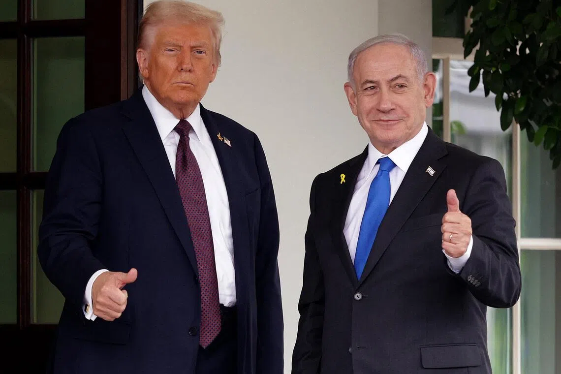 Two men in suits giving a thumbs-up gesture outdoors.