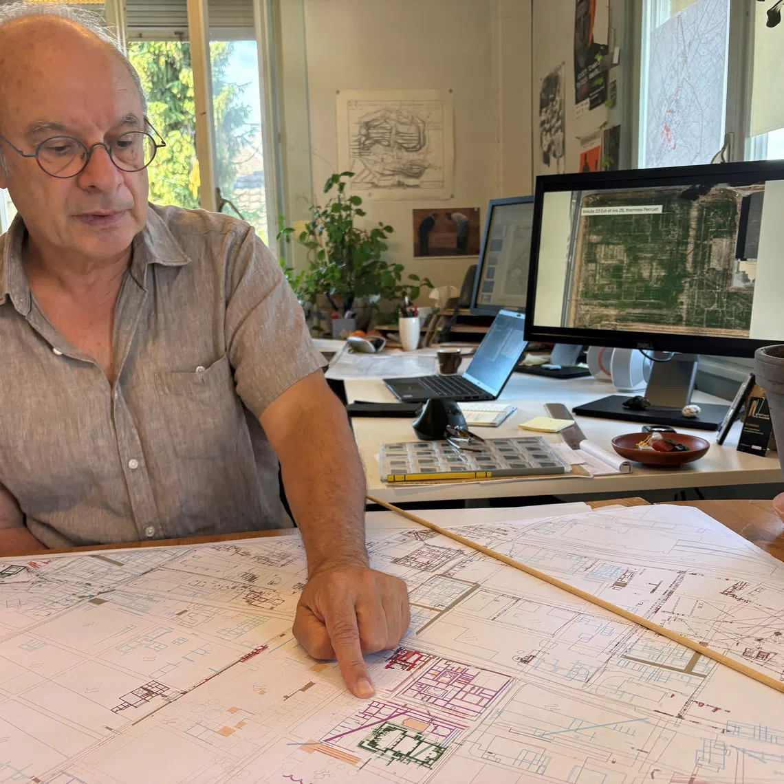 Archaeologist Pierre Blanc, head of excavations for the Roman site and museum of Avenches, points to new Roman buildings added to the map in purple after their outlines became visible from above in fields around Avenches, Vaud, Switzerland, September 28, 2026. REUTERS/Emma Farge