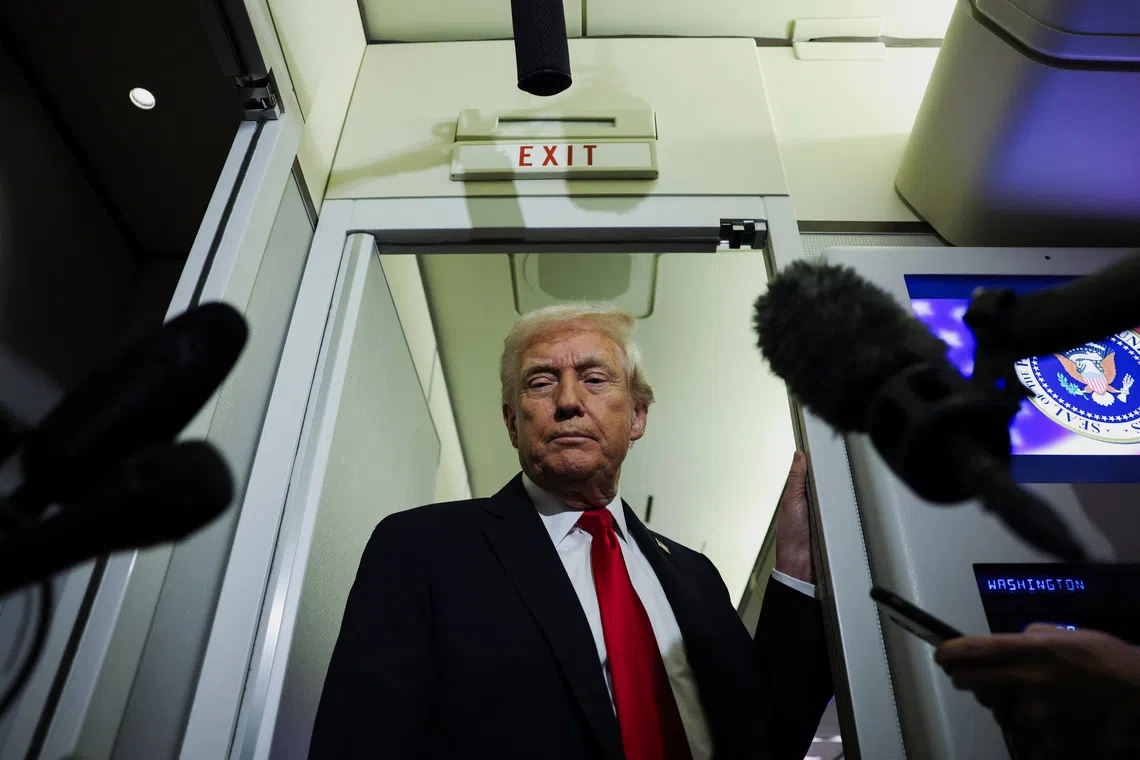 U.S. President Donald Trump looks on as he speaks to reporters aboard Air Force One during travel to Palm Beach, Florida, from Joint Base Andrews, Maryland, U.S., November 25, 2025. REUTERS/Anna Rose Layden
