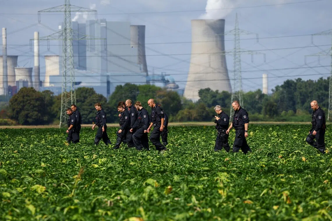 German police officers search a field near a power plant after a second sabotage attempt on Germany’s electricity grid, with local police saying they are investigating an attack on a substation in Bergheim, Germany.