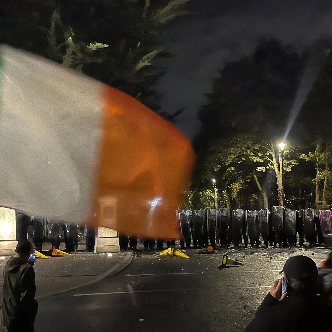 Protesters face a line of police at a demonstration outside a hotel housing asylum seekers in Saggart, south-west of Dublin in Ireland on Oct 21.
