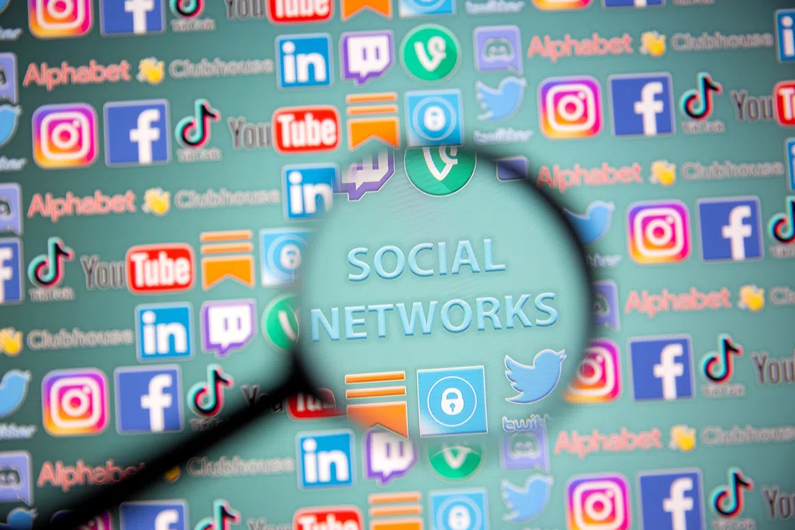 Social network words and social media logos are seen through magnifier displayed in this illustration taken, May 25, 2021. Picture taken May 25, 2021. REUTERS/Dado Ruvic/Illustration