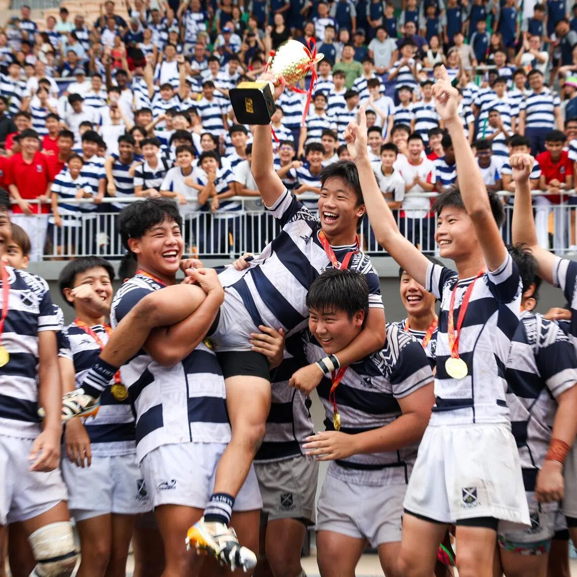 St Andrew's Secondary School rugby players lifting their captain Joshua Kee after winning the National School Games B Division Rugby Finals at Jurong West Stadium on April 1, 2026.