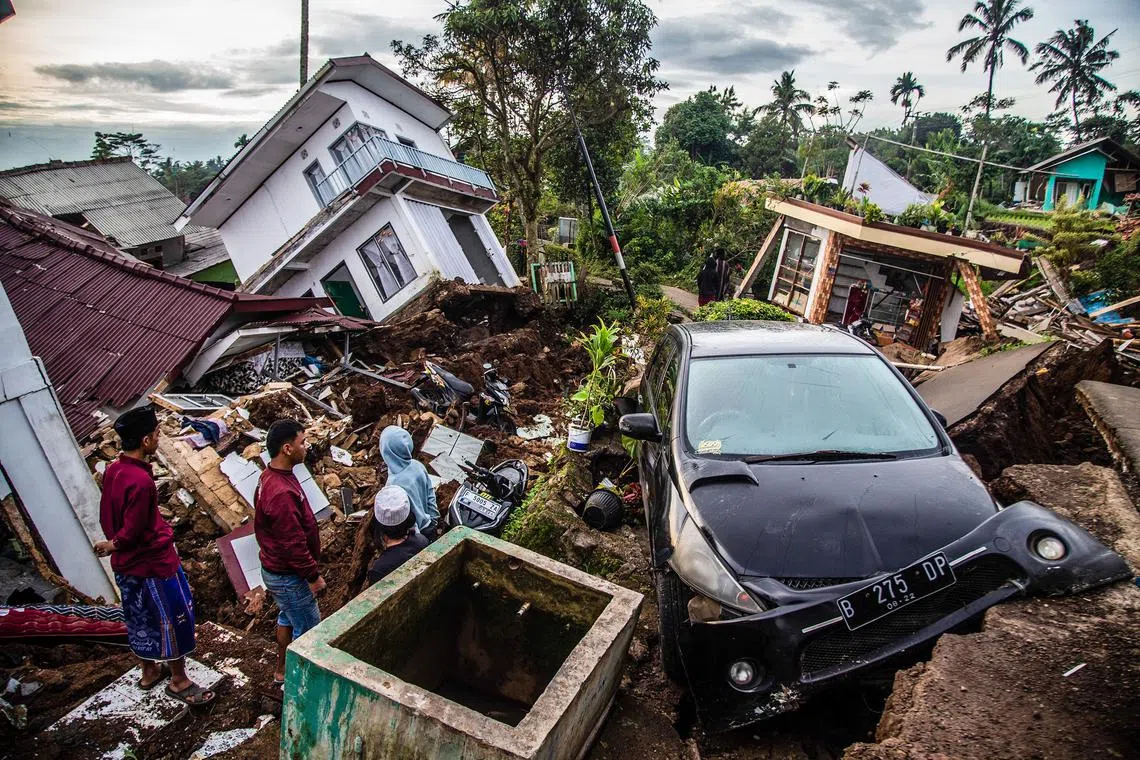 Villagers salvage items from damaged houses following a 5.6-magnitude earthquake that killed at least 162 people, with hundreds injured and others missing in Cianjur on Nov 22, 2022. 