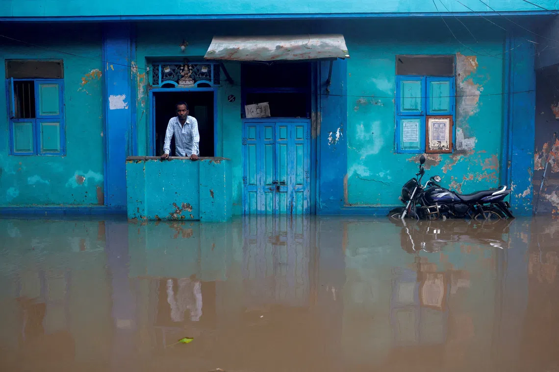 A man looking out from his flooded house as water rises, in the aftermath of Cyclone Ditwah in Chennai, India, on Dec 1, 2025. 