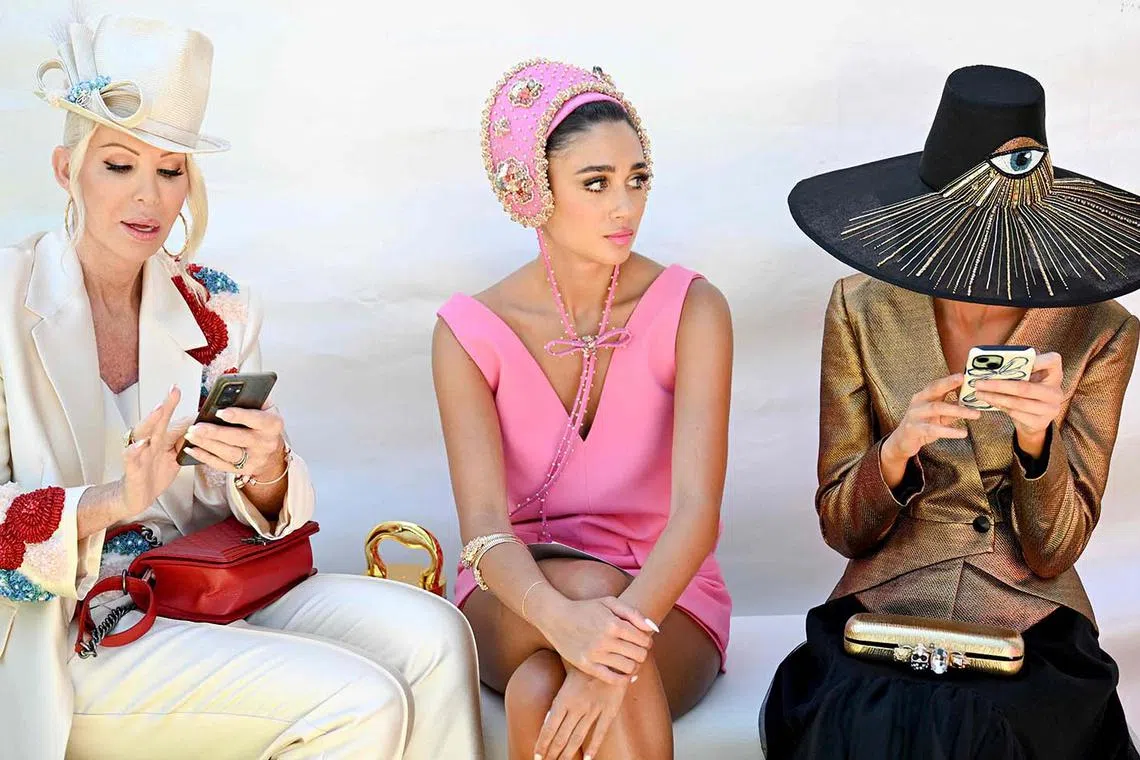 TOPSHOT - People wait to enter the Fashion on the Field event ahead of the Melbourne Cup horse race at the Flemington Racecourse in Melbourne on November 5, 2024. (Photo by William WEST / AFP) / -- IMAGE RESTRICTED TO EDITORIAL USE - STRICTLY NO COMMERCIAL USE --