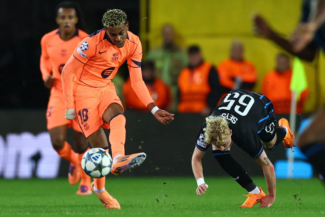 Soccer Football - UEFA Champions League - Club Brugge v FC Barcelona - Jan Breydel Stadium, Bruges, Belgium - November 5, 2025 FC Barcelona's Lamine Yamal in action with Club Brugge's Joaquin Seys REUTERS/Yves Herman