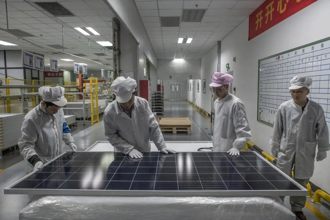 FILE Ñ Workers perform a quality check on a solar panel production line at a factory in Suzhou, China, Jan. 10, 2019. The solar sector shows how China conducts industrial policy, by choosing industries to dominate, flooding them with loans and letting companies fight it out. (Gilles SabriŽ/The New York TimeS)