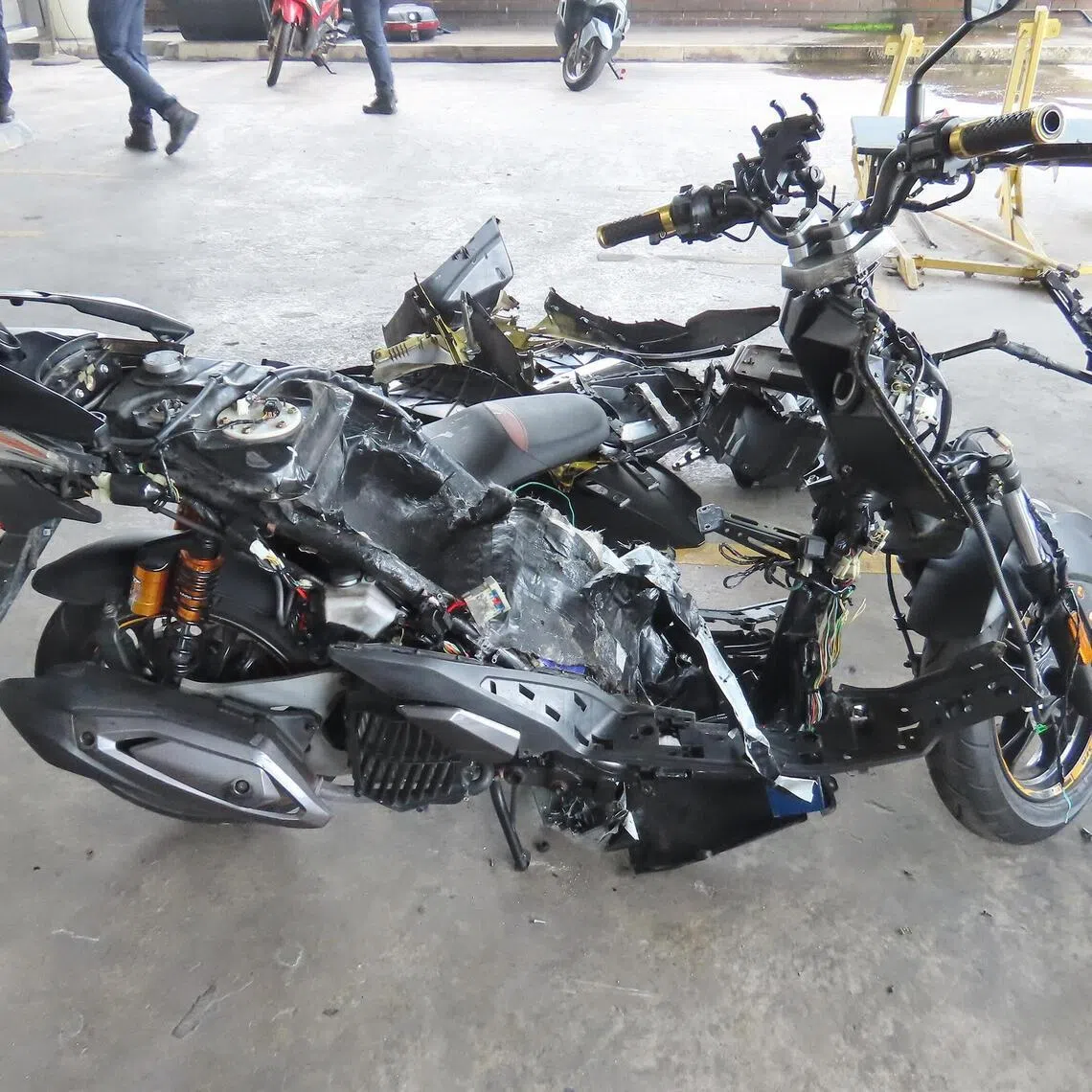 A motorcycle's bodywork taken apart after ICA officers flagged the vehicle for attempted smuggling of contraband cigarettes in 2025.