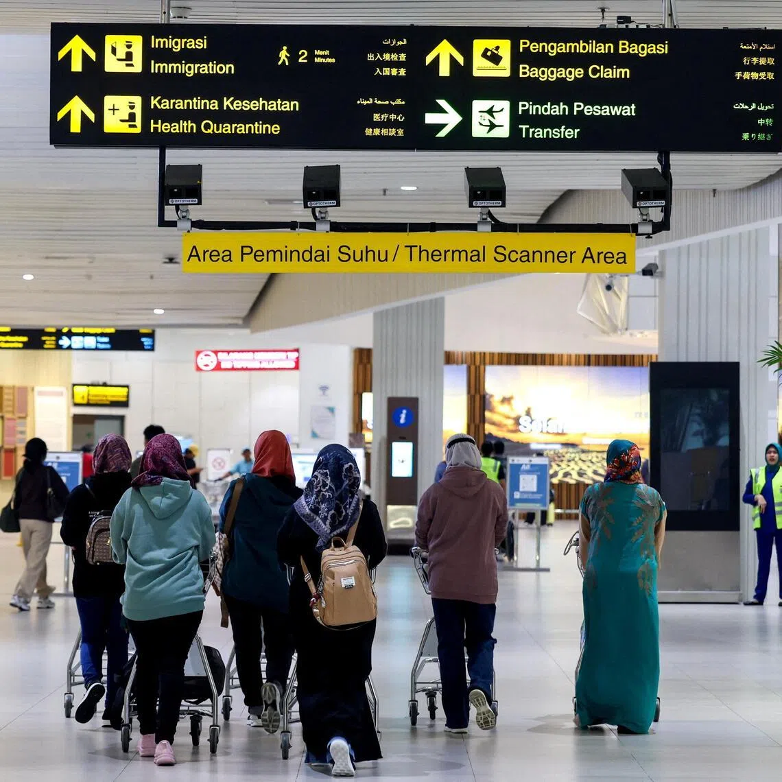 Passengers walk in the thermal scanner area at Soekarno Hatta International Airport in Tangerang near Jakarta, Indonesia, on Jan 30. 