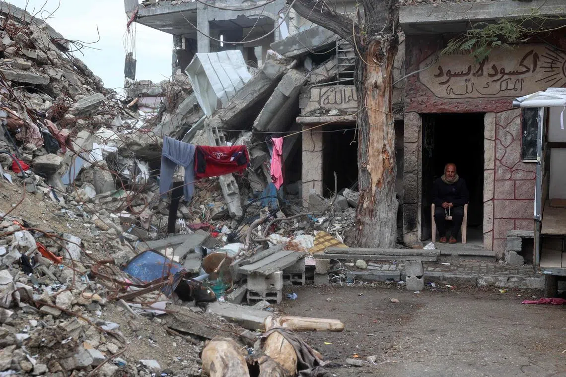 A Palestinian man sitting in the doorway of a war-damaged building  in the Nuseirat refugee camp, in the central Gaza Strip, on March 7.
