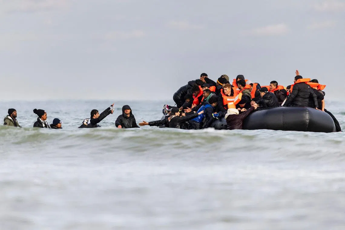 Migrants in northern France boarding a smuggler's boat in an attempt to cross the English Channel, on April 26, 2024.