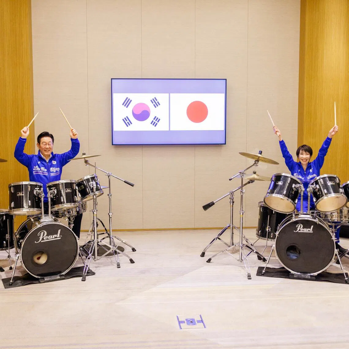 Mr Lee Jae Myung and Ms Sanae Takaichi playing the drums, in a photo posted on Ms Takaichi's X account.