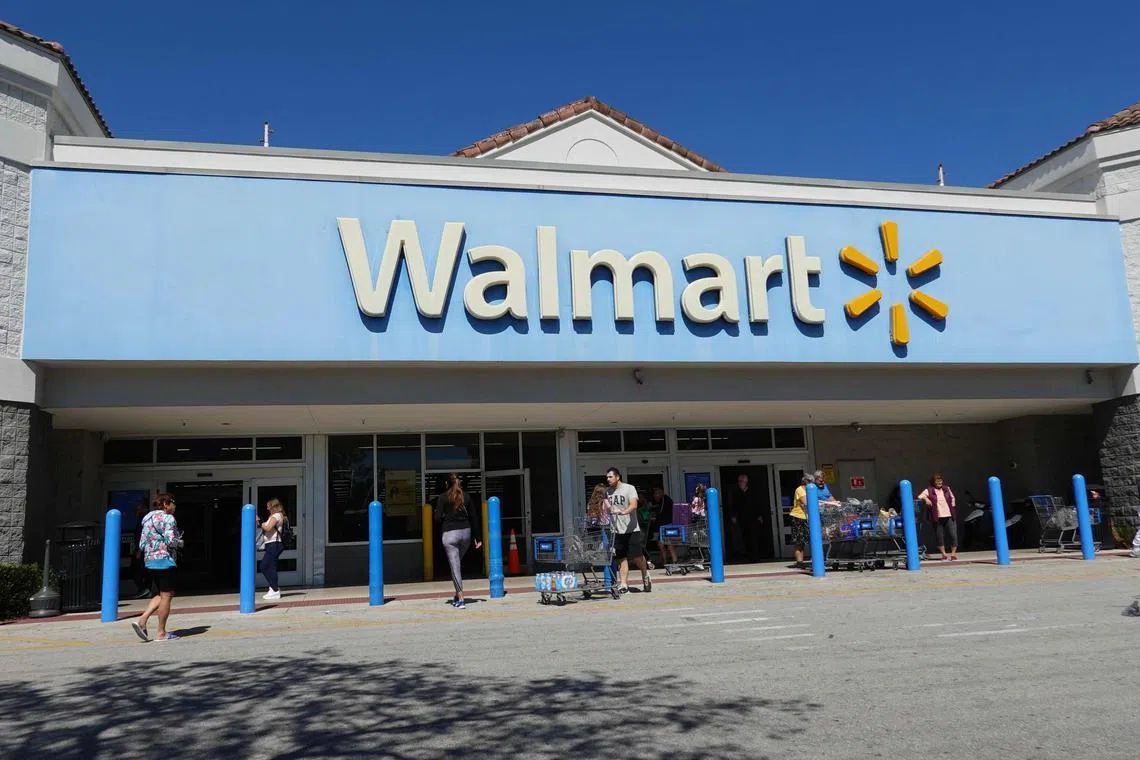 HALLANDALE BEACH, FLORIDA - FEBRUARY 20: People walk near the entrance to a Walmart Supercenter on February 20, 2024, in Hallandale Beach, Florida. Walmart reported that quarterly revenue rose 6%, and that the company’s global e-commerce sales have also grown.   Joe Raedle/Getty Images/AFP (Photo by JOE RAEDLE / GETTY IMAGES NORTH AMERICA / Getty Images via AFP)