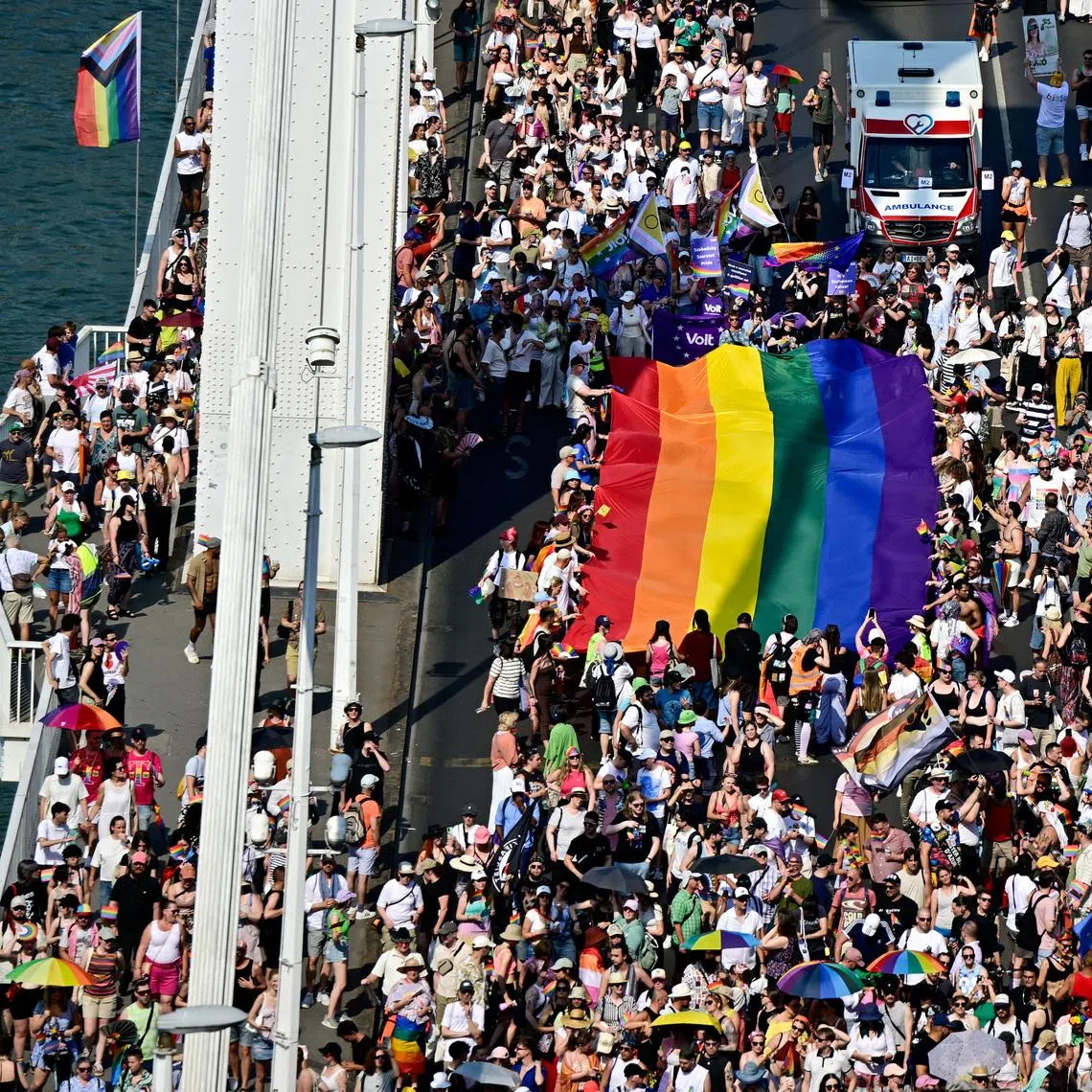People cross Elizabeth Bridge with a rainbow flag as they attend the Budapest Pride March in Budapest, Hungary, June 27, 2026. REUTERS/Marton Monus