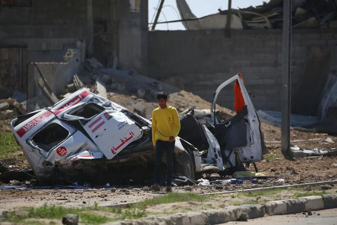 Palestinians inspect the damage at an ambulance repair yard hit in Israeli strikes in the al-Maghazi refugee camp in the central Gaza Strip on March 24, 2025. (Photo by Eyad BABA / AFP)