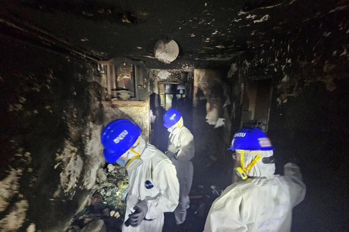 Members of the Hong Kong Police Force's Disaster Victims Identification Unit (DVIU) operate during a search operation at the Wang Fuk Court housing complex, in Hong Kong, China, November 30, 2025. Hong Kong Police Force/Handout via REUTERS    THIS IMAGE HAS BEEN SUPPLIED BY A THIRD PARTY. NO RESALES. NO ARCHIVES. MANDATORY CREDIT.