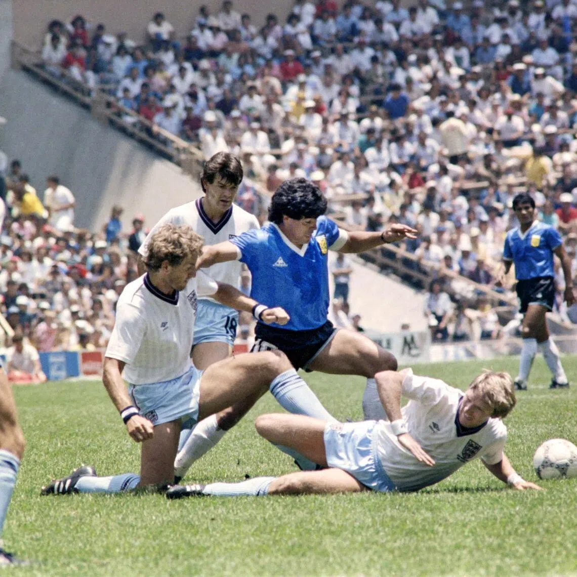 Argentina's Diego Maradona dribbles past three English defenders on June 22, 1986 in Mexico City during their World Cup quarter-final match.