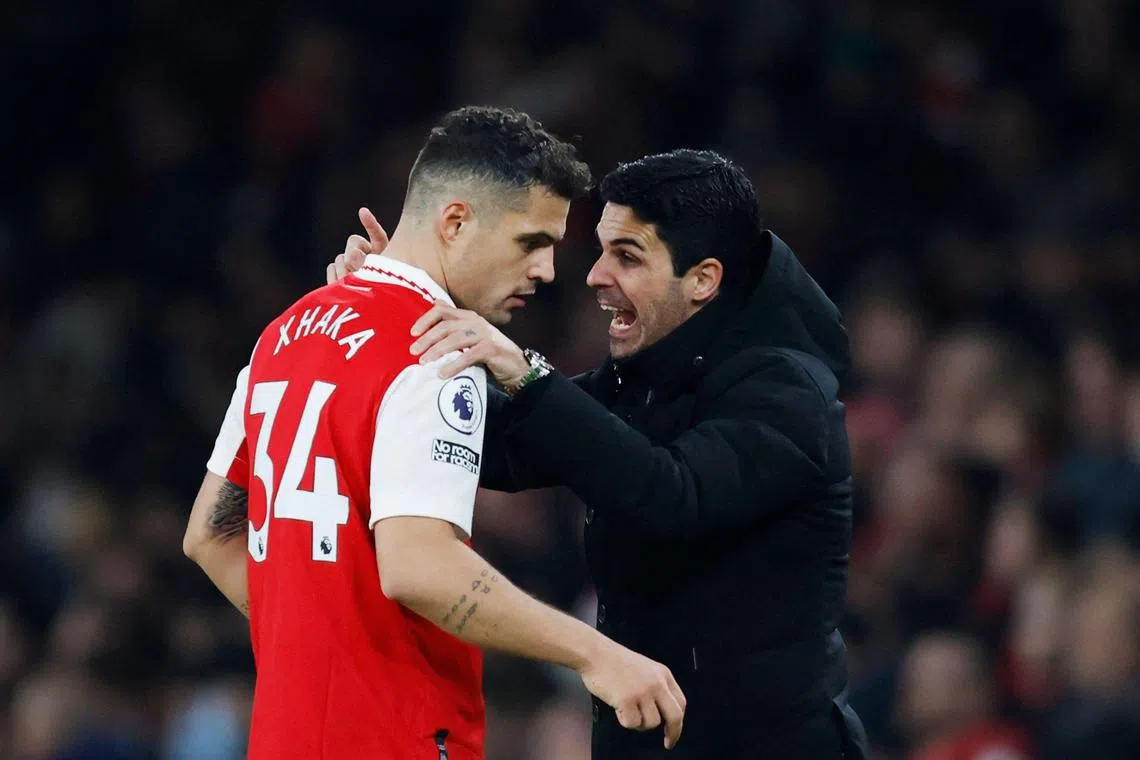 Arsenal manager Mikel Arteta speaking to Swiss midfielder Granit Xhaka during the 3-1 loss to Manchester City.