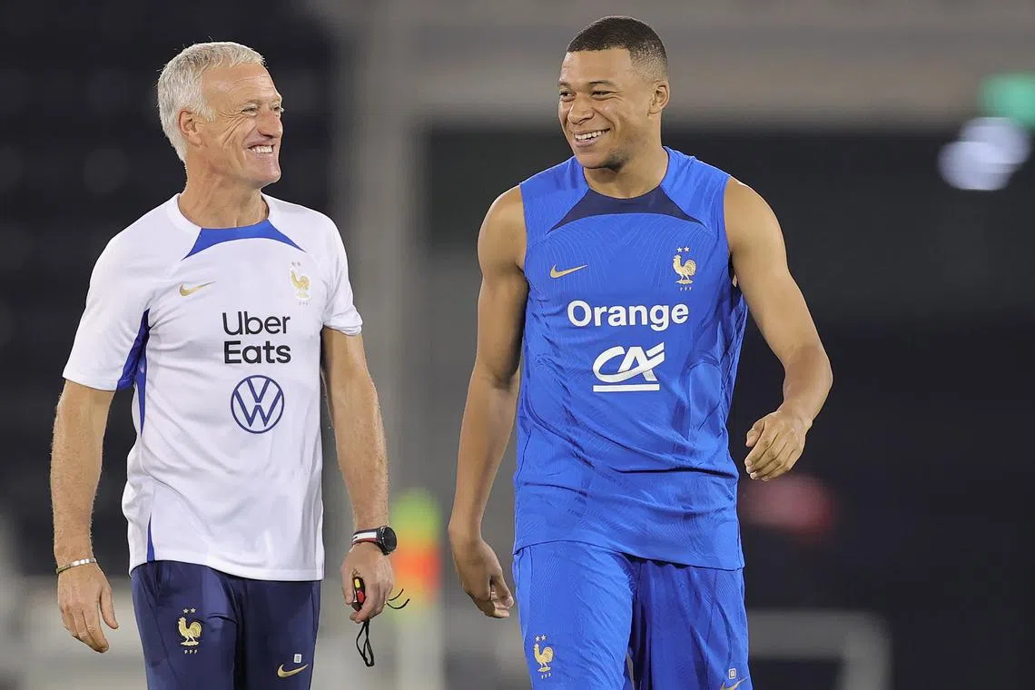 French coach Didier Deschamps (left) with Kylian Mbappe during a training session in Doha on Nov 17.