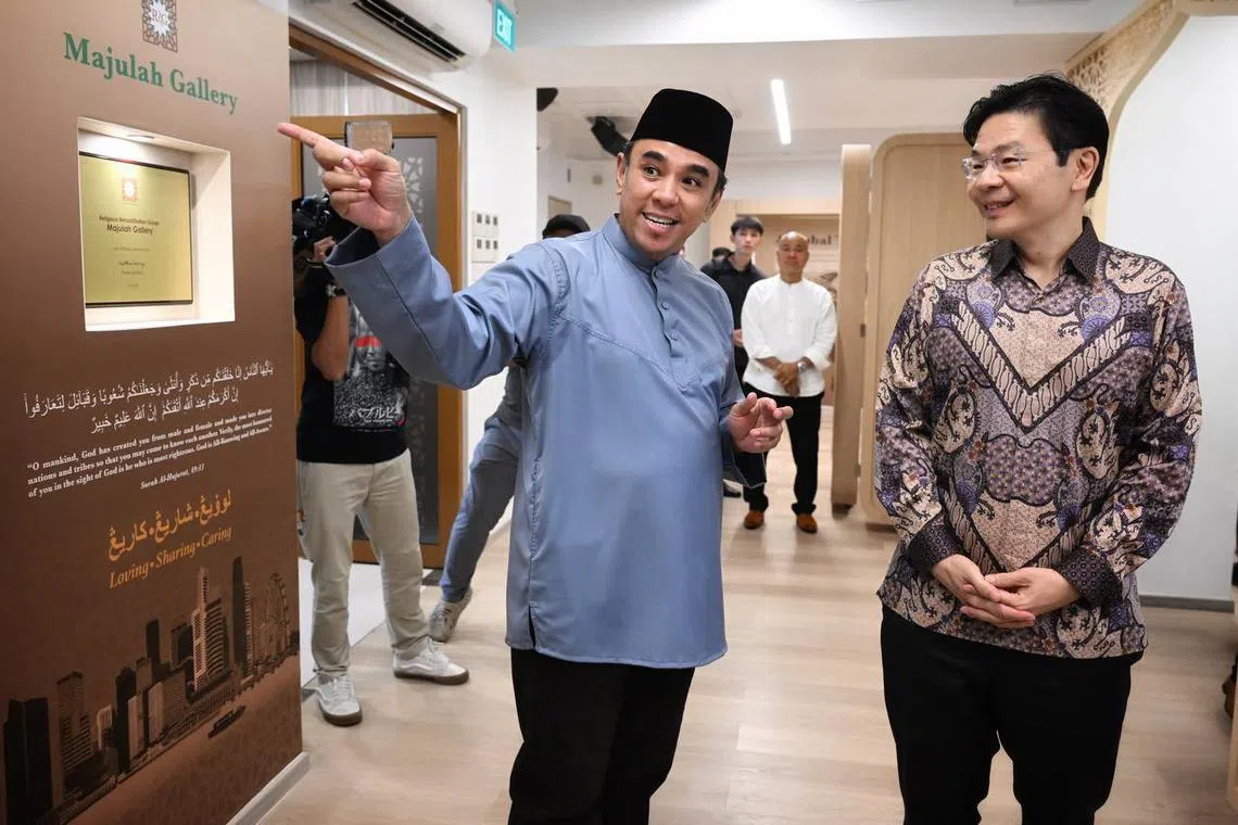 Ustaz Dr Mohamed Bin Ali (left), Chairman, Khadijah Mosque and Co-Chairman of the RRG, with DPM Lawrence Wong on a tour of the RRG gallery at Khadijah Mosque.