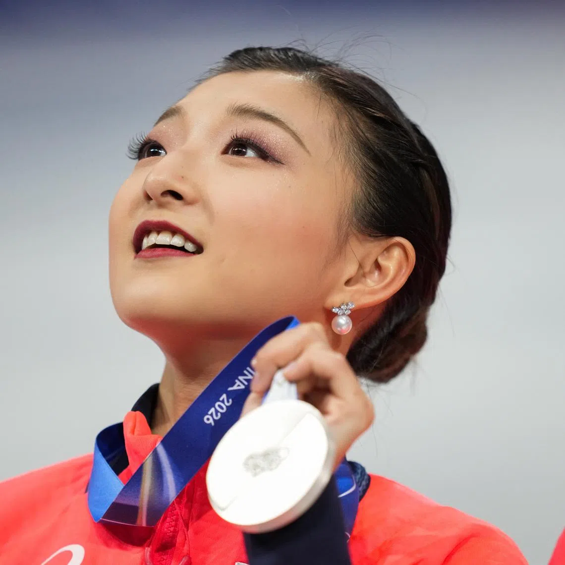 Feb 8, 2026; Milan, Italy; Kaori Sakamoto of Japan celebrates winning silver in the team figure skating event during the Milano Cortina 2026 Olympic Winter Games at Milano Ice Skating Arena. Mandatory Credit: James Lang-Imagn Images