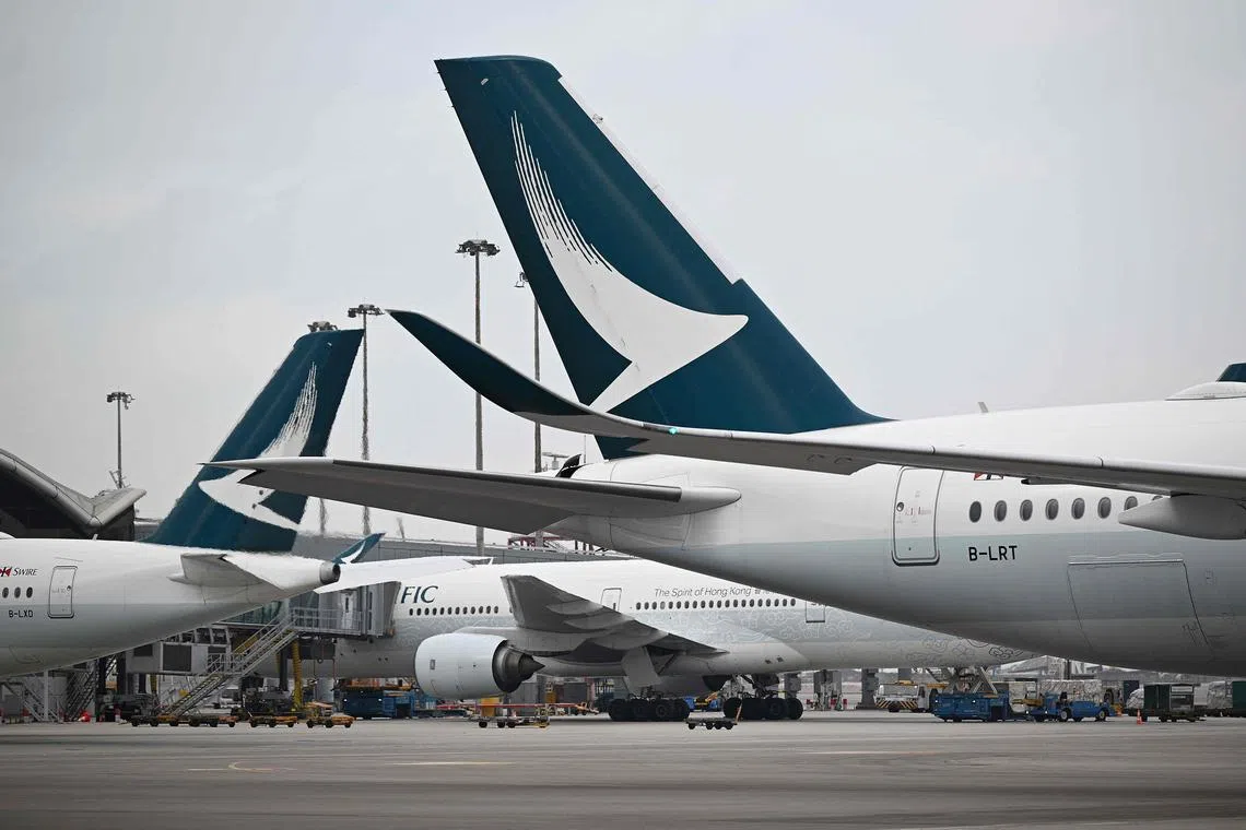 (FILES) This photo taken on December 13, 2023 shows Cathay Pacific aircraft parked at Hong Kong International Airport. (Photo by Peter PARKS / AFP)