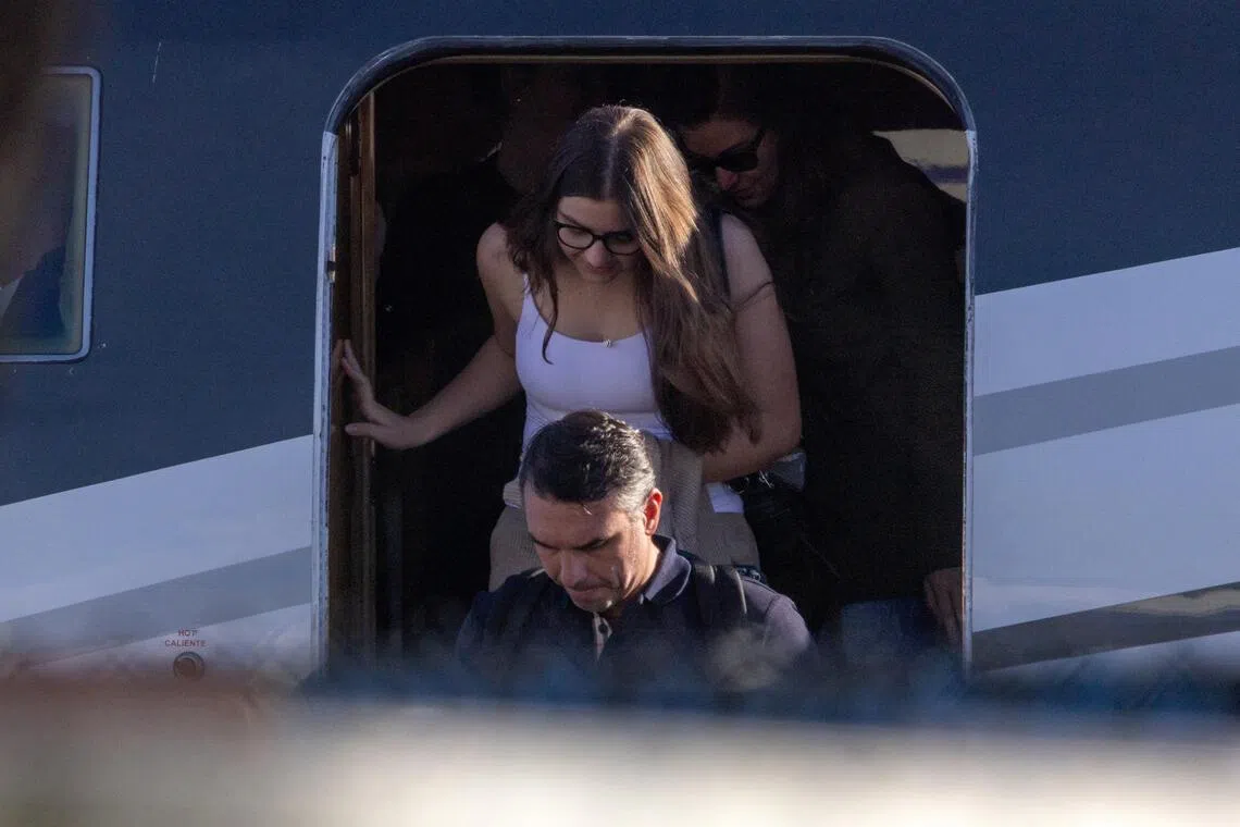 Brazilian Senator Flavio Bolsonaro disembarking from a plane with his family after arriving in the US state of Florida on Oct 28.