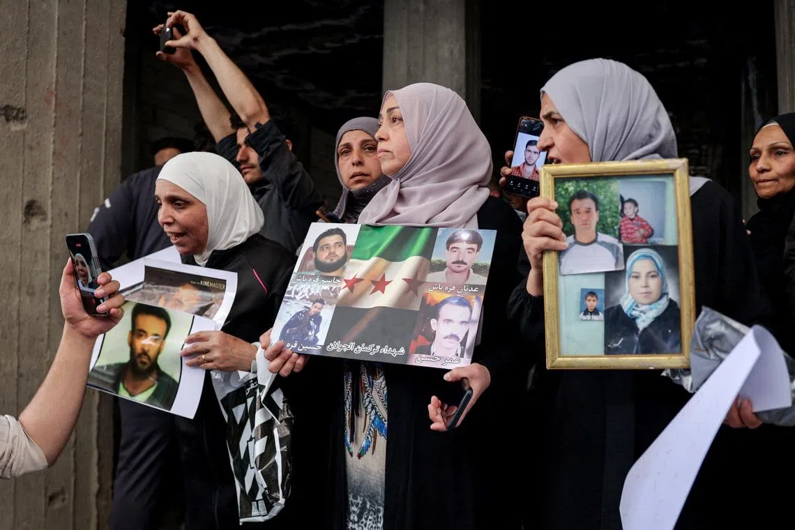 Residents gather in a street after Friday prayers to celebrate the arrest of Amjad Yousef, a key suspect in the 2013 Tadamon massacre, in Tadamon, Syria, April 24, 2026. REUTERS/Khalil Ashawi