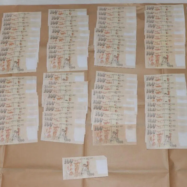 A search revealed 121 counterfeit Singapore $100 notes in the duo’s possession.