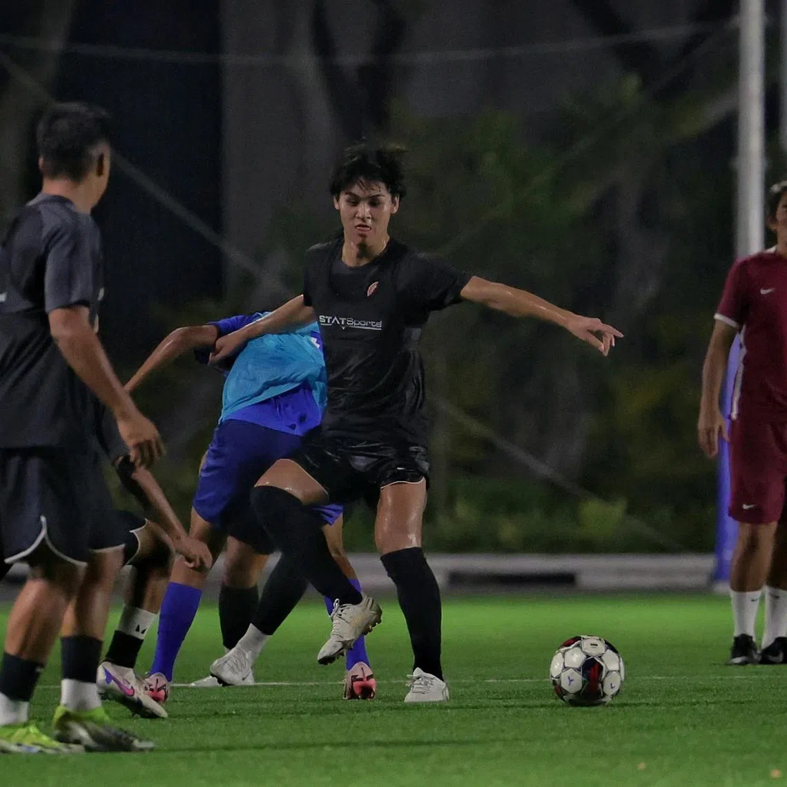 Young Lions' Kaisei Ogawa tussling for the ball under the watchful eyes of coach Nazri Nasir. The Japanese midfielder joined from Albirex Niigata in 2024.