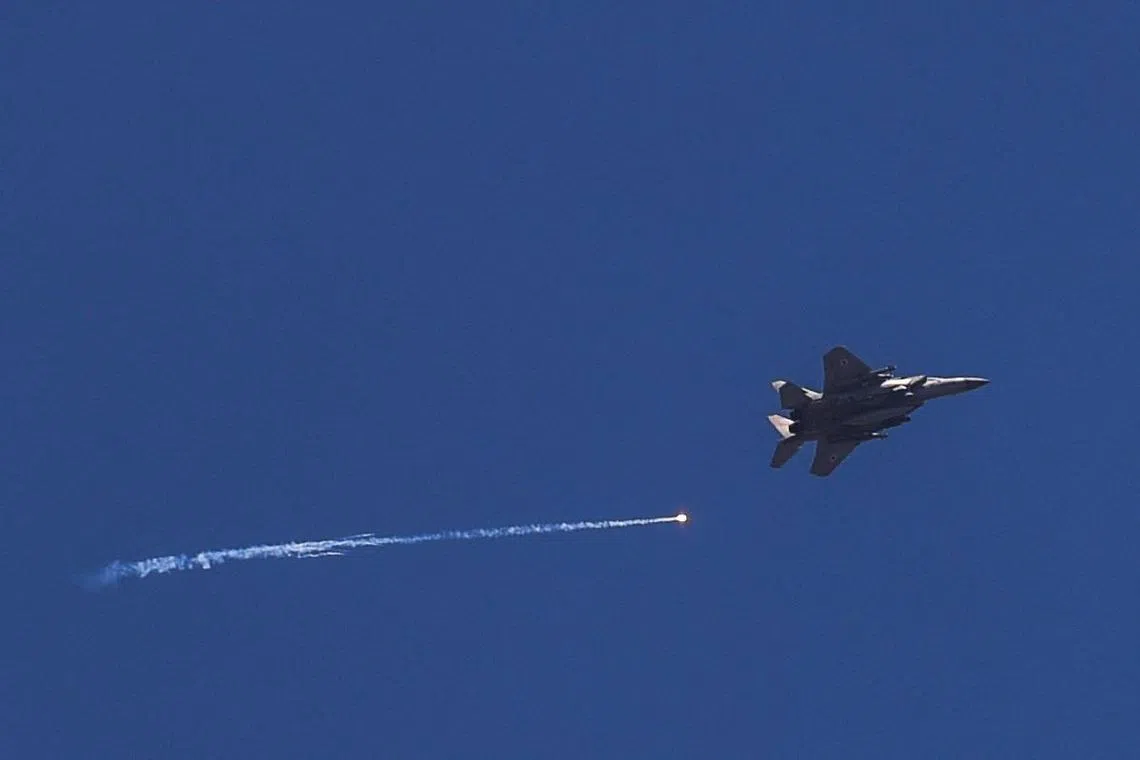 An Israeli war jet flies over the Israel Lebanon border amid ongoing cross-border hostilities between Hezbollah and Israeli forces on June 13.