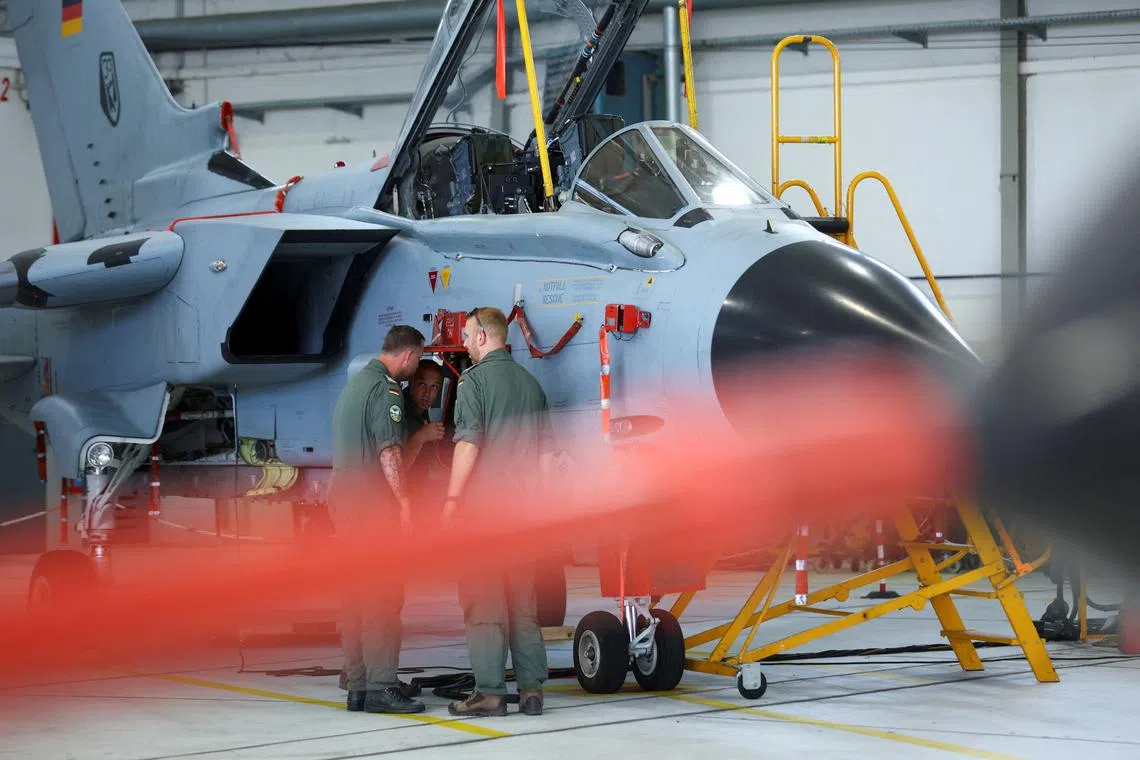 FILE PHOTO: Members of the military work on PA-200 Tornado combat aircraft at an air base of German army Bundeswehr, in Buechel, Germany, July 18, 2024. REUTERS/Thilo Schmuelgen/File Photo
