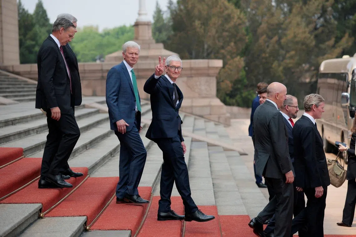 Apple CEO Tim Cook gesturing as he leaves after attending a welcome ceremony for US President Donald Trump with Chinese President Xi Jinping at the Great Hall of the People in Beijing, China, May 14.