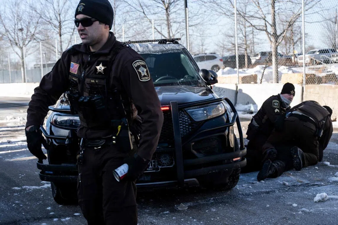 An activist being arrested by police in Minneapolis on Jan 23, after protesters attempted to block a street in front of the Bishop Henry Whipple Federal Building.